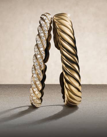 Three David Yurman Sculpted Cable bracelets.