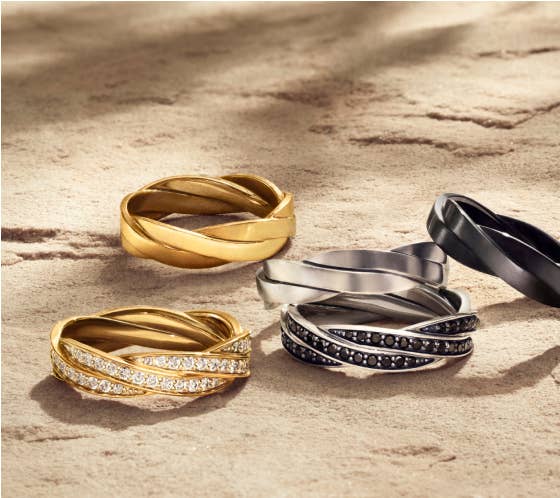 A collection of David Yurman rings in a variety of metals and styles.
