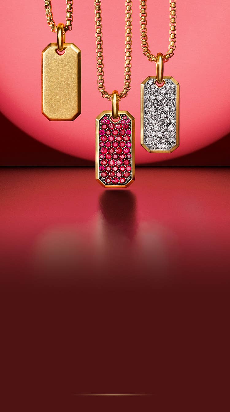 An image of three mens tags in yellow gold with pave diamonds and rubies.