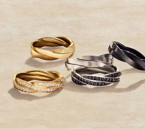 A collection of five David Yurman Helios rings in a variety of metals and styles.