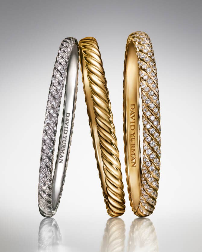 Three David Yurman Sculpted Cable bracelets.