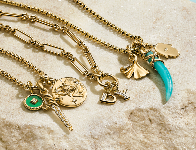 Shop this image of 8 yellow gold amulets on gold chains.