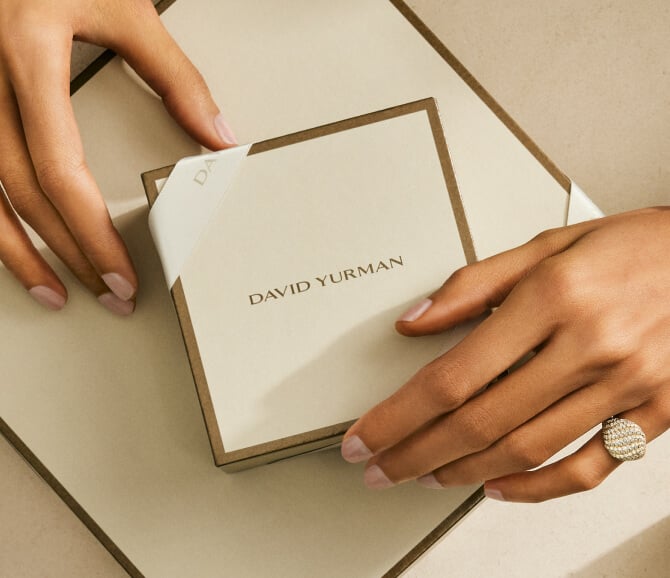 A woman holding David Yurman packaging.