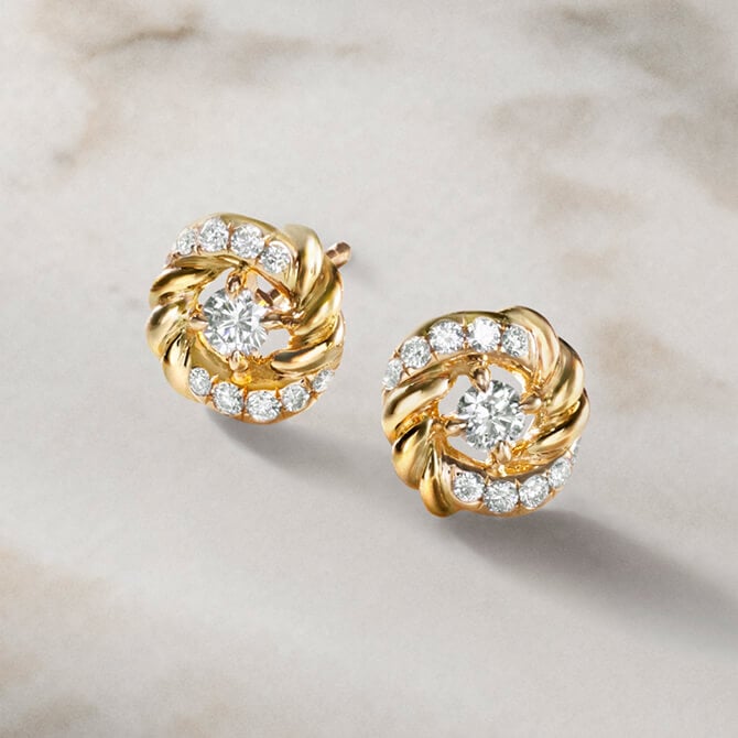 18K gold and pave set diamond infinity earrings.