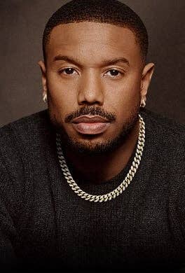 Michael B. Jordan posing in David Yurman Curb Chain jewelry.