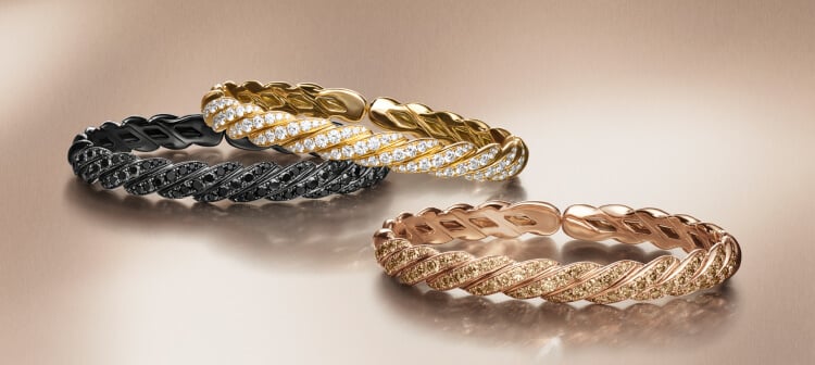 Three David Yurman Sculpted Cable bracelets.