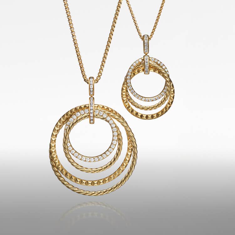 Two David Yurman Crossover Trio pendants.