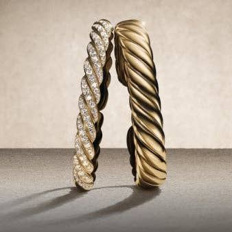 Three David Yurman Sculpted Cable bracelets.