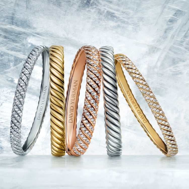 An image of five David Yurman Sculpted Cable bracelets.