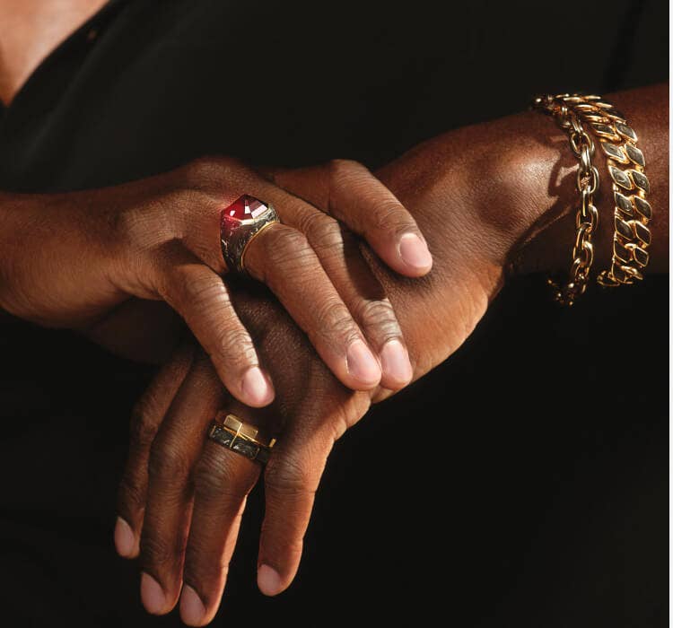 An image of Aldis Hodge wearing Forged Carbon bracelets and necklaces.