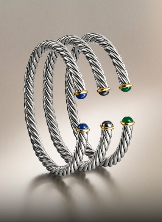 Three David Yurman bracelets for men.