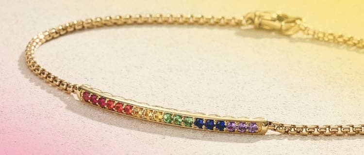 An image of a gold pave rainbow bracelet with the David Yurman and Trevor Project logos.