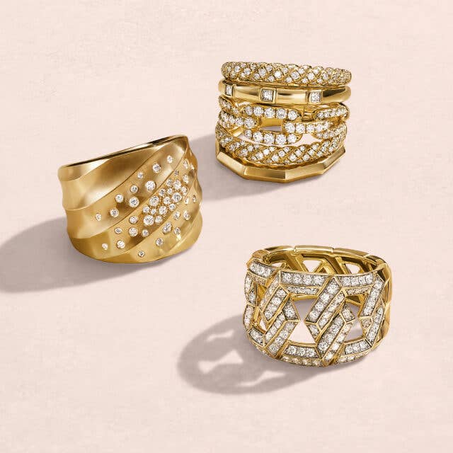 Three David Yurman gold statment rings with diamonds.