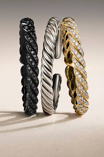 Three David Yurman bracelets.