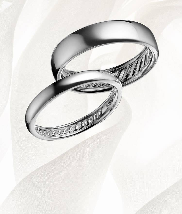 An image of two platinum smooth David Yurman band rings.