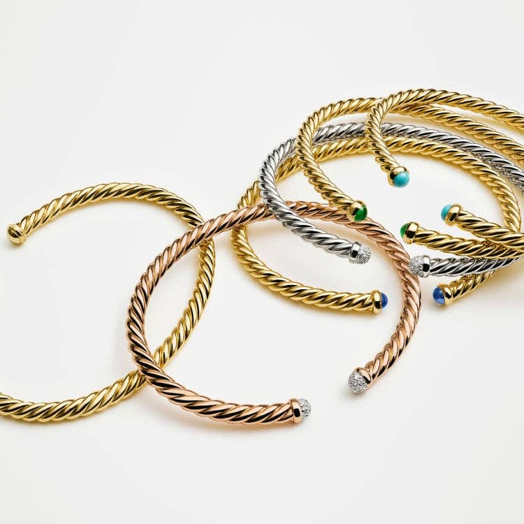 An image of 6 CableSpira bracelets in yellow, white and rose gold.
