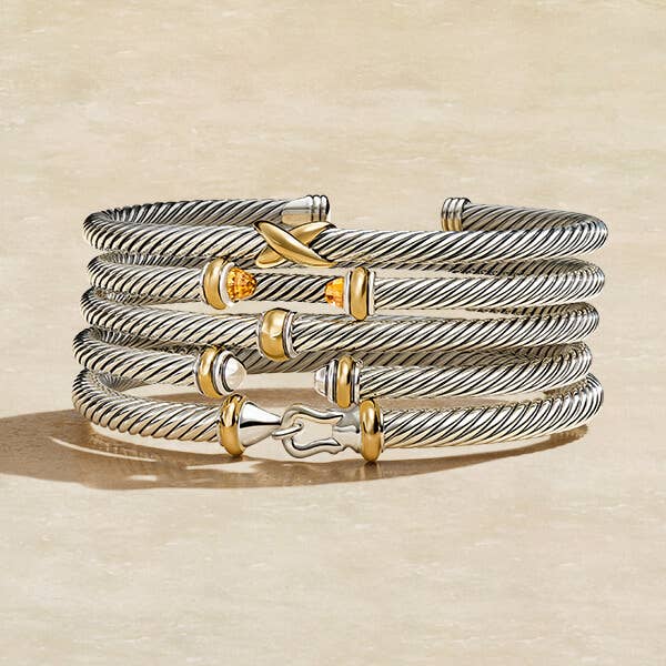 Stack of David Yurman Bracelets with mixed metals.