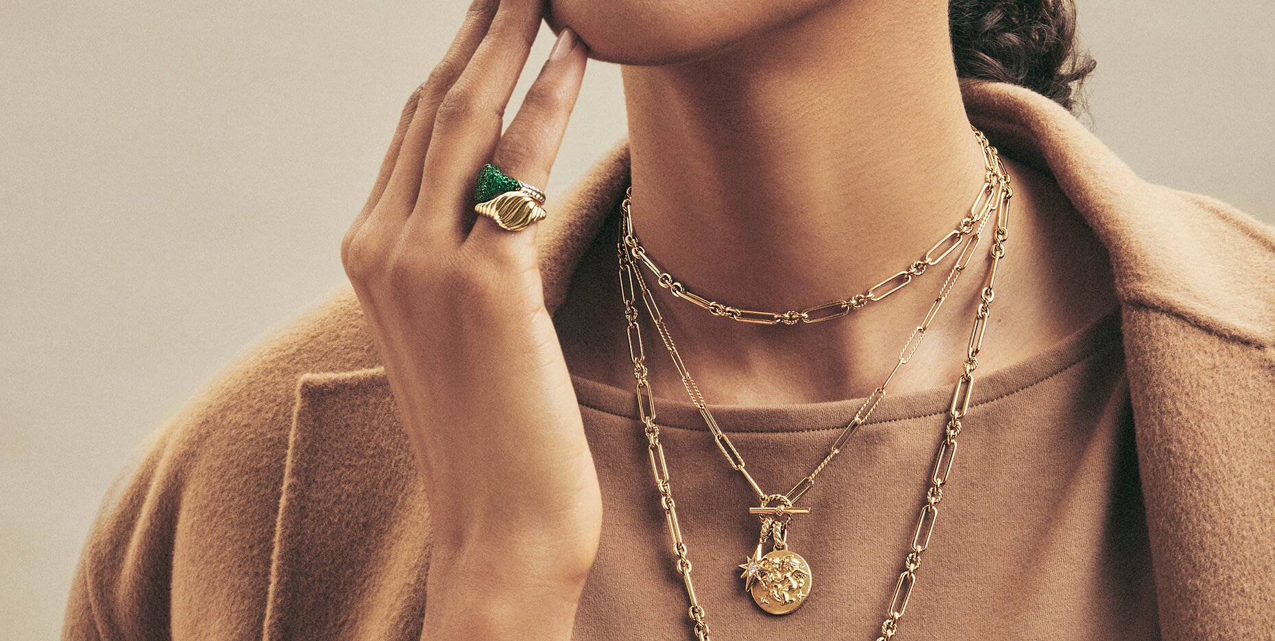 Model layering David Yurman necklaces, bracelets, and rings.