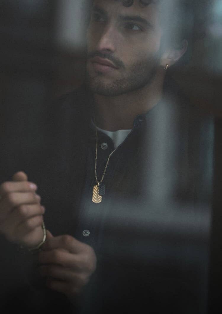 A male model wearing David Yurman Chevron jewelry.