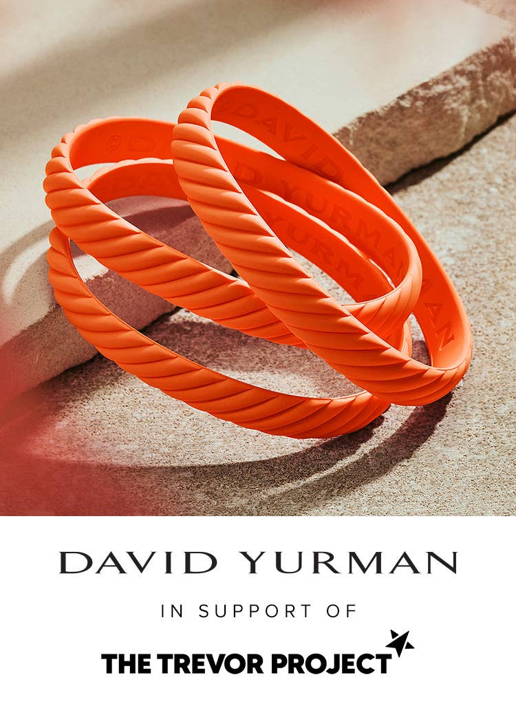 An image of orange rubber bracelets with the Trevor Project and David Yurman logo.