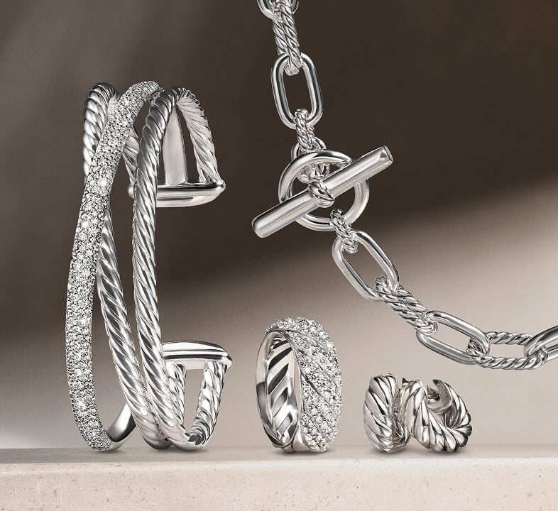 A David Yurman necklace, bracelet, ring and pair of earrings in silver.