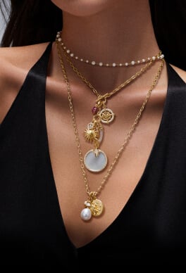 A model wearing multiple David Yurman amulets.