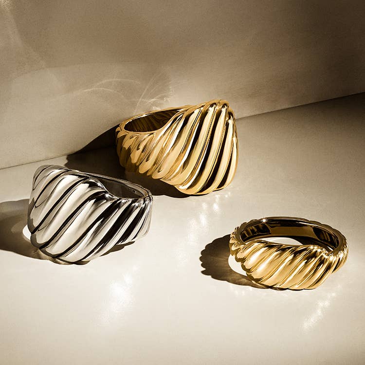 An image of three sculpted contour rings in silver and gold.