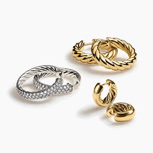 Three pairs of David Yurman hoop earrings in silver and gold.