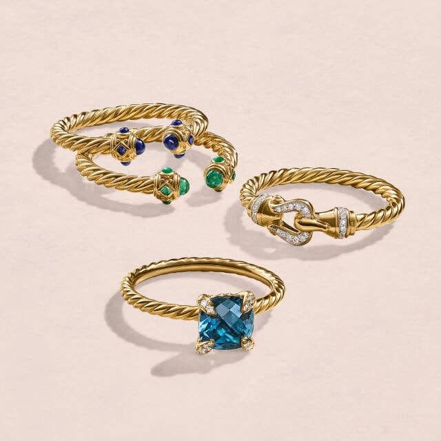 Four different David Yurman petite rings in gold. 