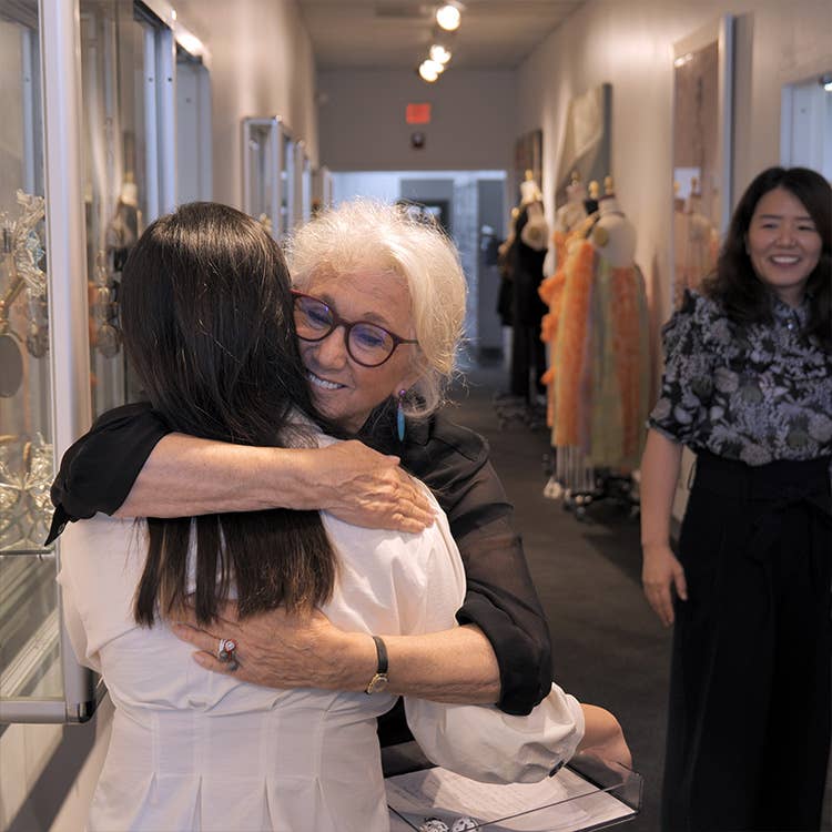 An image of Sybil Yurman hugging a student from SCAD.