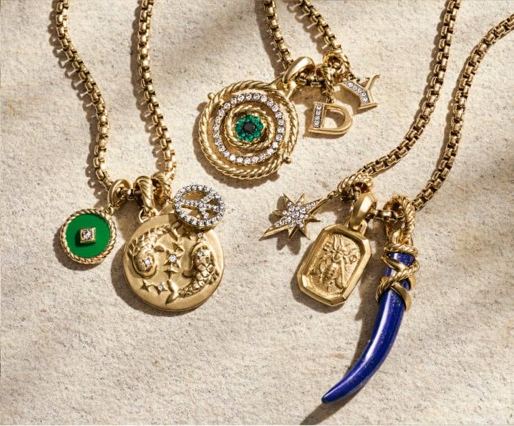An image of a gold charm bracelets with multiple amulets attached.