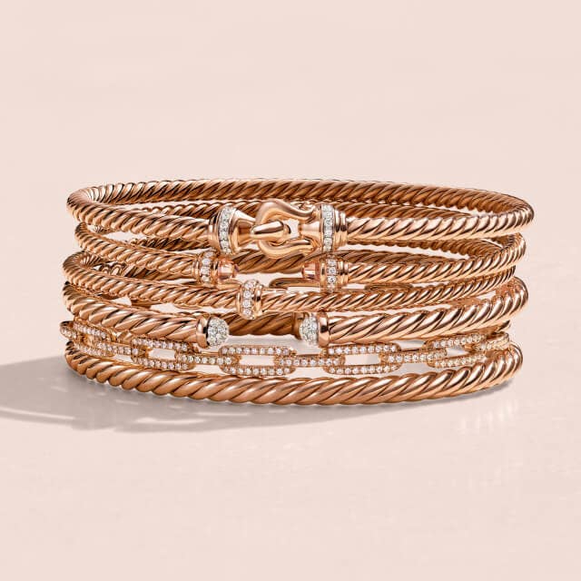 Stack of David Yurman bracelets in Rose Gold. 