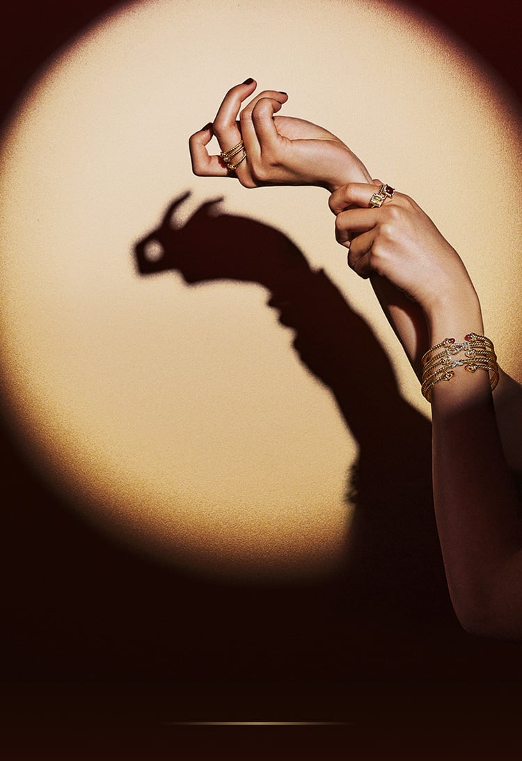 An image of a model making a bunny shadow with her hands.