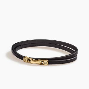 David Yurman black leather bracelet with gold clasp.