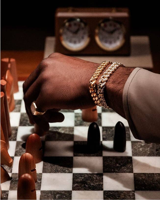 Jaylen Brown wearing David Yurman jewelry and playing chess.