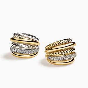 Two David Yurman gold and silver statement rings with diamonds.