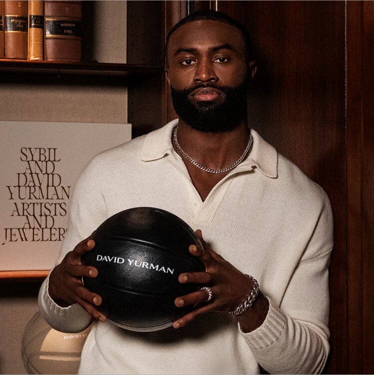 Jaylen Brown holding a basketball and wearing David Yurman jewelry.
