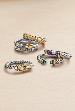 Five David Yurman rings in mixed metals for women.
