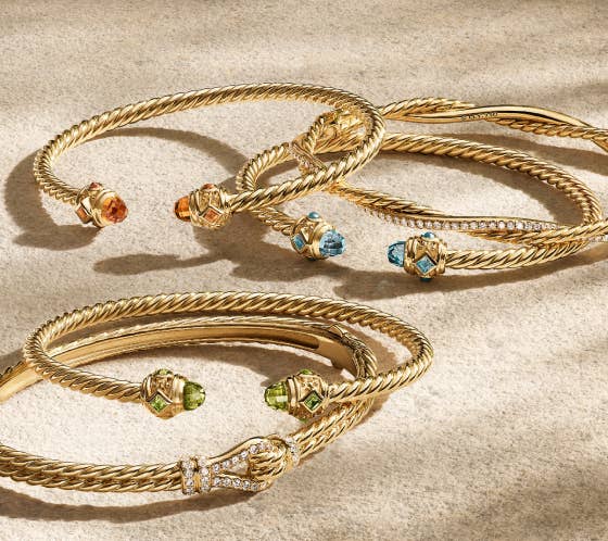 A mix of 6 different gold David Yurman cable bracelets.