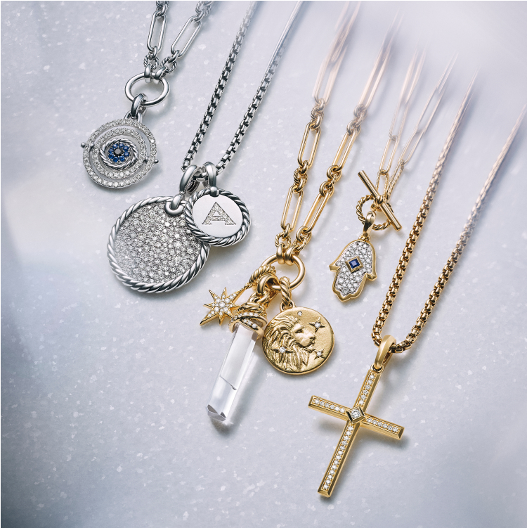 An image of David Yurman amulets in gold and silver.