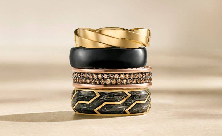 An image of four wedding bands stacked on top of each other.