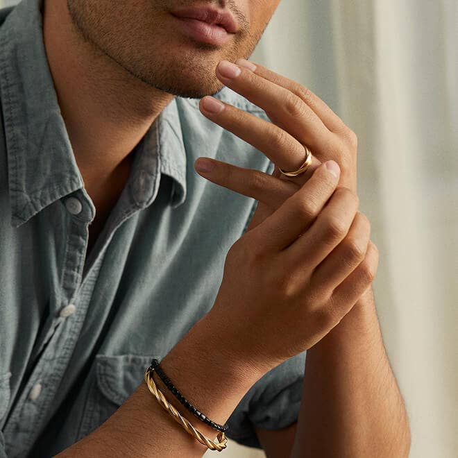 Model wearing David Yurman rings.