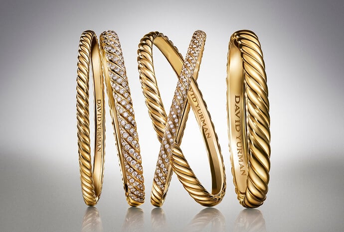 Five David Yurman bangles in gold.