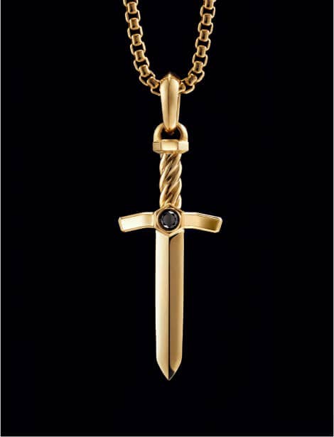 An image of a gold sword amulet.