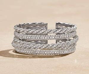 A 17mm gold and a 24mm silver David Yurman Cable Edge&#174; Cuff Bracelet.