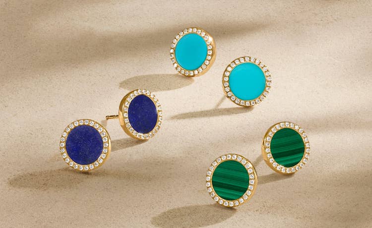 An image of three sets of gold petite element stud earrings.