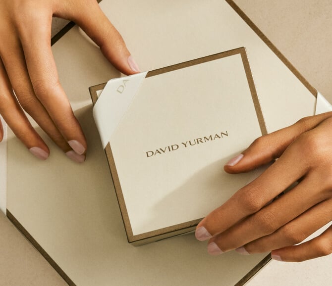Hands holding a David Yurman gift box.