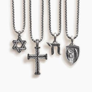 A variety of David Yurman pendants featuring religious symbols.