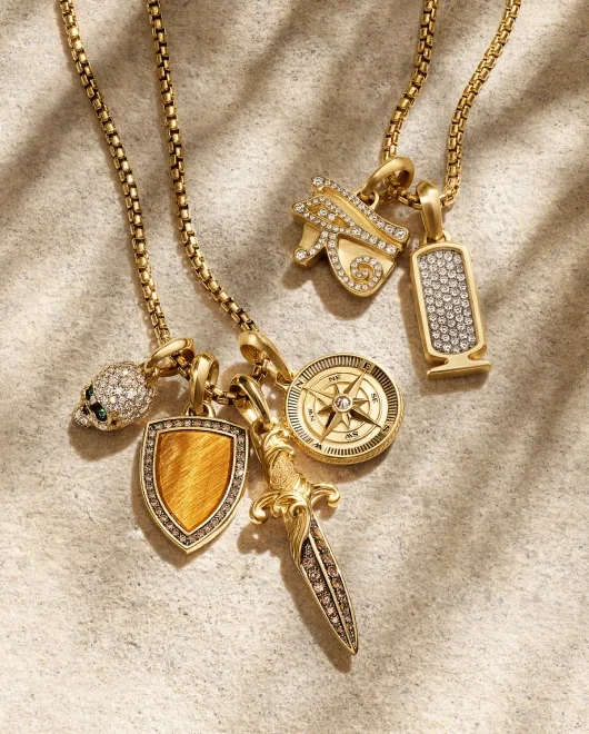 A collection of David Yurman pendants on gold box chains.