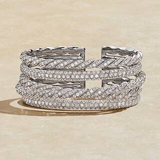 Stack of David Yurman bracelets in White Gold.